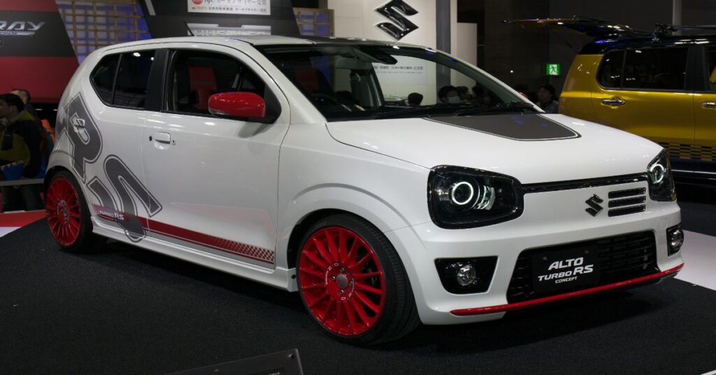 White Suzuki Alto with bold red rims